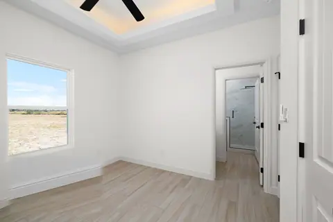 Secondary bedroom opening to a bathroom with a glass shower