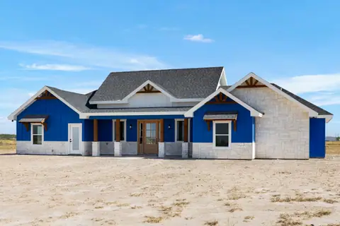 Front porch with cedar posts on a blue ranch home with white stone