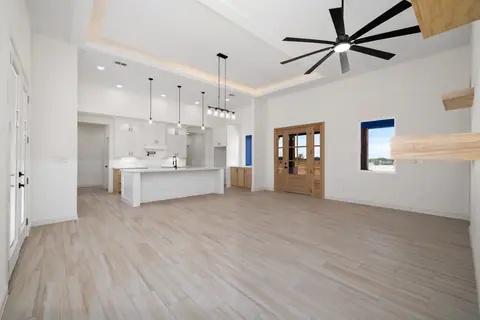 Living room with a wood front door, French doors and a wood-look plank floor