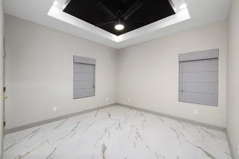 Secondary bedroom with a lit black tray ceiling