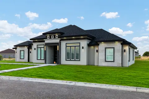 Front entry of a gray stucco home with black window trim
