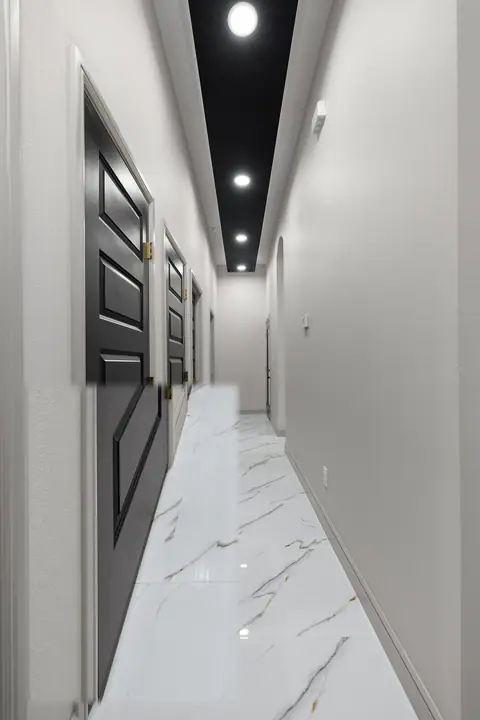 Hallway with a black ceiling, black doors and marble-look tile