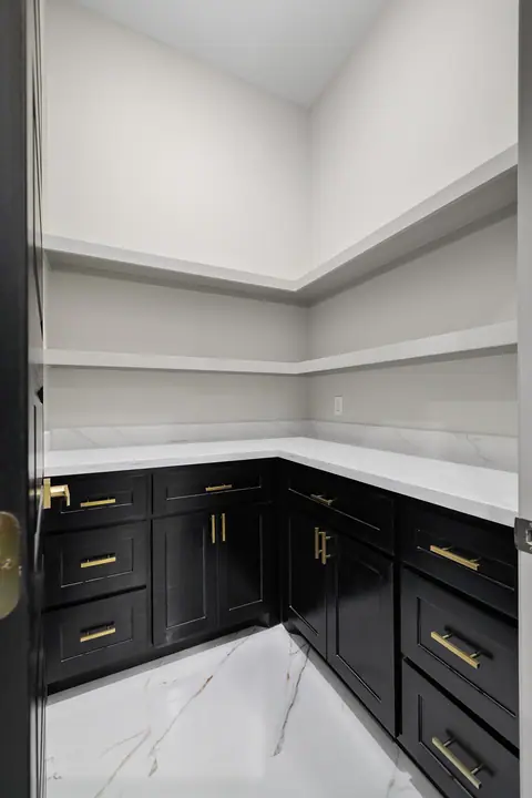 Pantry with black base cabinets and white open shelves