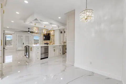 Breakfast area with a crystal chandelier looking back into the kitchen
