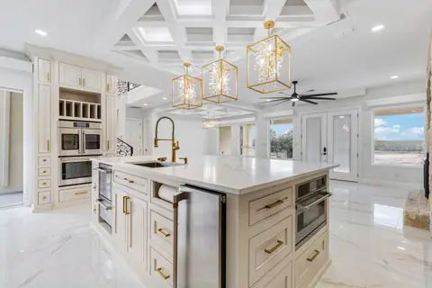 Kitchen with double wall ovens, a coffee bar and a long island