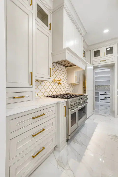 Cooking wall with a pot filler and a doorway into the walk-in pantry