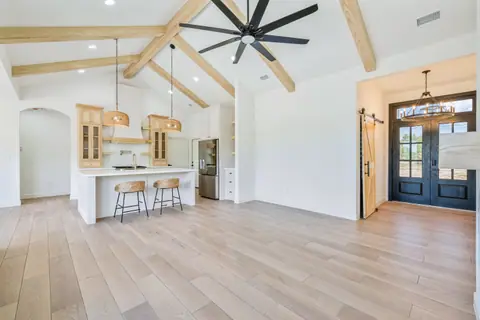Kitchen and entry with black double front doors and a sliding barn door